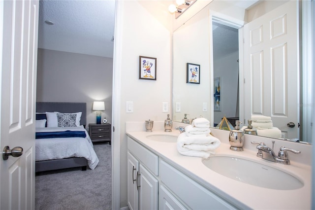 9071 Sunshine Ridge Loop, Kissimmee, FL 34747 - bathroom featuring double vanity, connected bathroom, and a textured ceiling