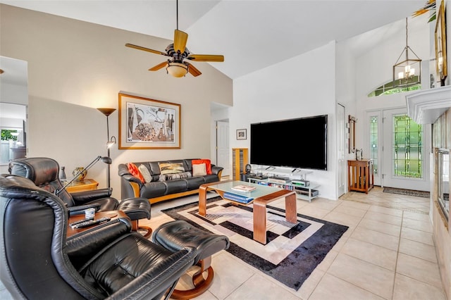 6630 Hidden Beach Cir, Orlando, FL 32819 - living room with high vaulted ceiling, light tile patterned floors, and a ceiling fan