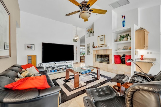 6630 Hidden Beach Cir, Orlando, FL 32819 - living room with built in features, tile patterned flooring, a ceiling fan, high vaulted ceiling, and a fireplace