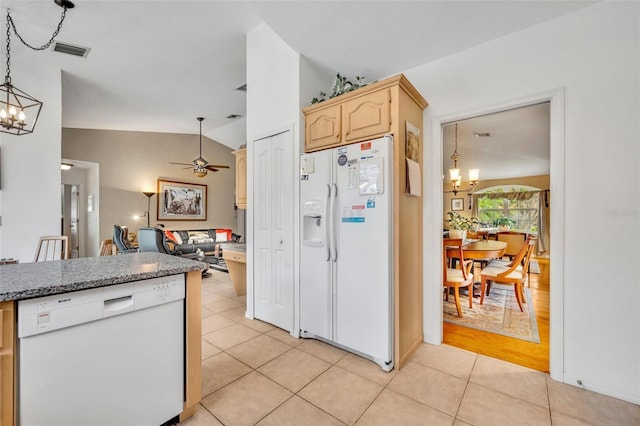 6630 Hidden Beach Cir, Orlando, FL 32819 - kitchen featuring white appliances, a chandelier, vaulted ceiling, open floor plan, and light tile patterned flooring