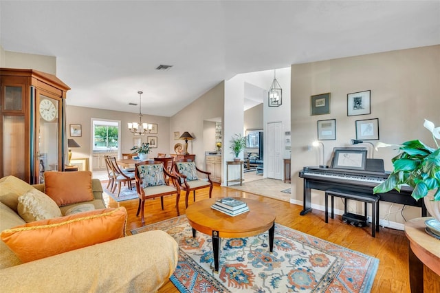 6630 Hidden Beach Cir, Orlando, FL 32819 - living area featuring a chandelier, light wood-style flooring, and lofted ceiling