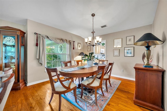 6630 Hidden Beach Cir, Orlando, FL 32819 - dining space featuring a chandelier and light wood-style floors