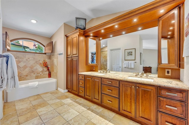 6630 Hidden Beach Cir, Orlando, FL 32819 - bathroom featuring double vanity, a tub, and recessed lighting