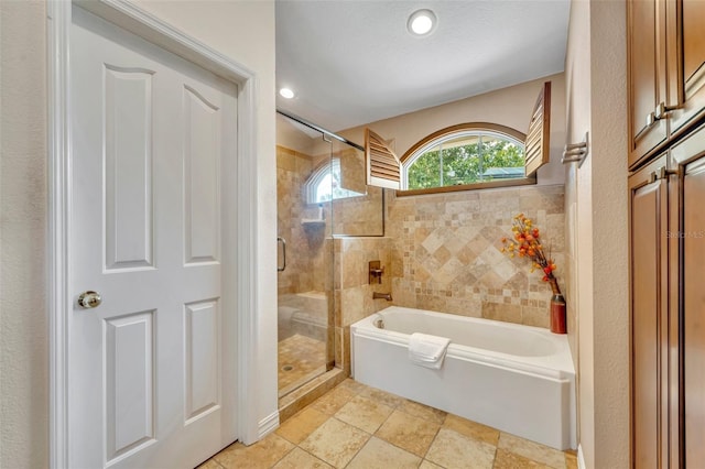 6630 Hidden Beach Cir, Orlando, FL 32819 - full bathroom featuring a bath, a shower stall, and recessed lighting