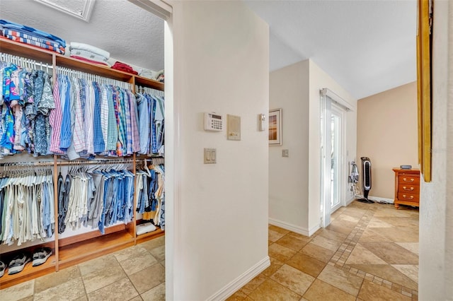 6630 Hidden Beach Cir, Orlando, FL 32819 - hallway with baseboards and attic access