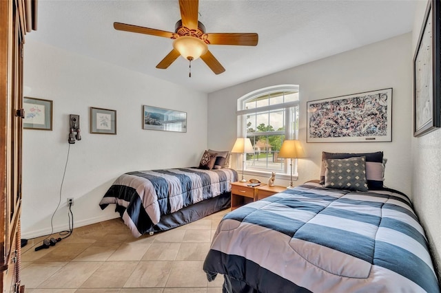6630 Hidden Beach Cir, Orlando, FL 32819 - bedroom with light tile patterned floors and a ceiling fan