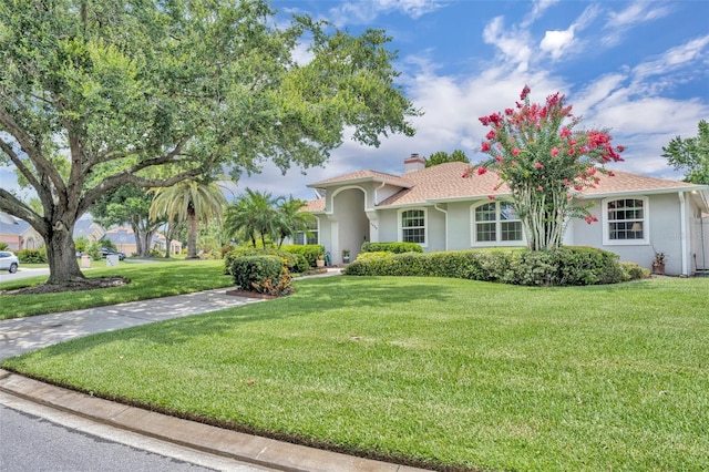 6630 Hidden Beach Cir, Orlando, FL 32819 - view of front of property featuring a chimney, a front lawn, and stucco siding