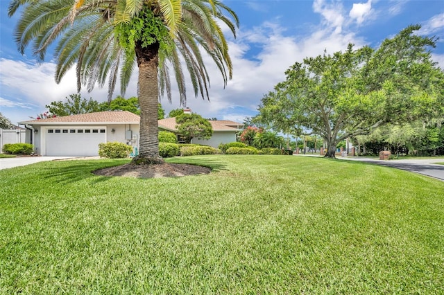 6630 Hidden Beach Cir, Orlando, FL 32819 - view of front of house with an attached garage, a front lawn, driveway, and stucco siding