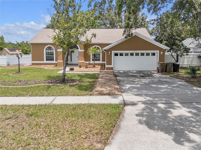 12713 Pine Arbor Dr, Clermont, FL 34711 - ranch-style house with an attached garage, stucco siding, and driveway