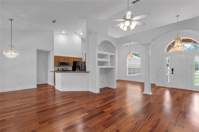 12713 Pine Arbor Dr, Clermont, FL 34711 - foyer entrance with a chandelier, decorative columns, ceiling fan, dark wood finished floors, and high vaulted ceiling