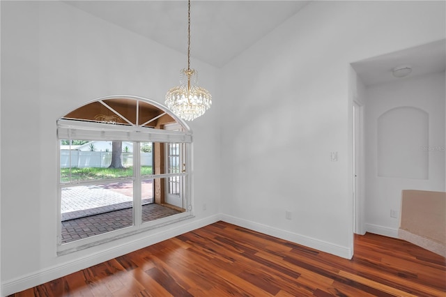 12713 Pine Arbor Dr, Clermont, FL 34711 - unfurnished dining area with wood finished floors, a chandelier, and lofted ceiling