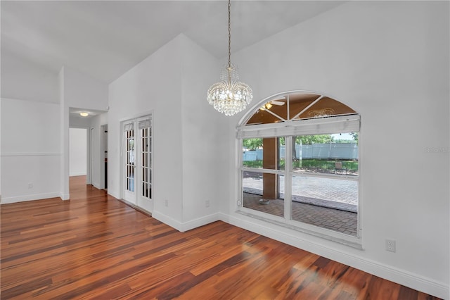 12713 Pine Arbor Dr, Clermont, FL 34711 - empty room featuring high vaulted ceiling, wood finished floors, and a chandelier