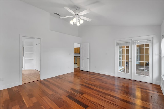 12713 Pine Arbor Dr, Clermont, FL 34711 - spare room featuring ceiling fan, wood finished floors, high vaulted ceiling, and french doors