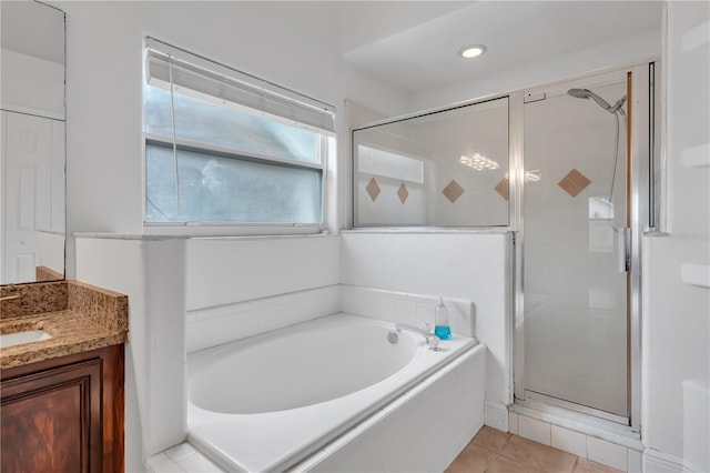 12713 Pine Arbor Dr, Clermont, FL 34711 - bathroom featuring a shower stall, a garden tub, vanity, and tile patterned flooring