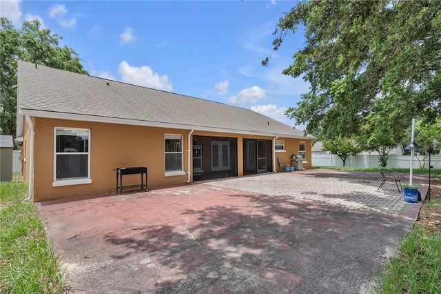 12713 Pine Arbor Dr, Clermont, FL 34711 - rear view of house with a patio, stucco siding, and roof with shingles