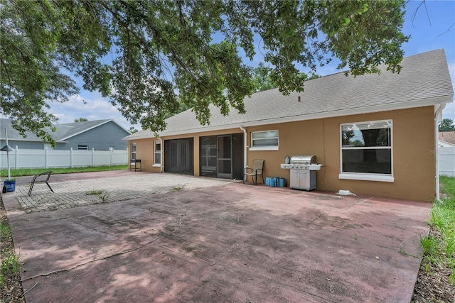 12713 Pine Arbor Dr, Clermont, FL 34711 - rear view of house with stucco siding, a shingled roof, a patio, and a sunroom
