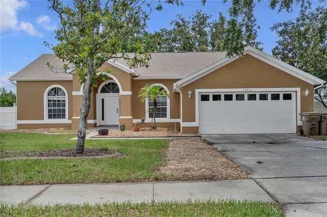 12713 Pine Arbor Dr, Clermont, FL 34711 - single story home featuring stucco siding, an attached garage, concrete driveway, a front yard, and a shingled roof