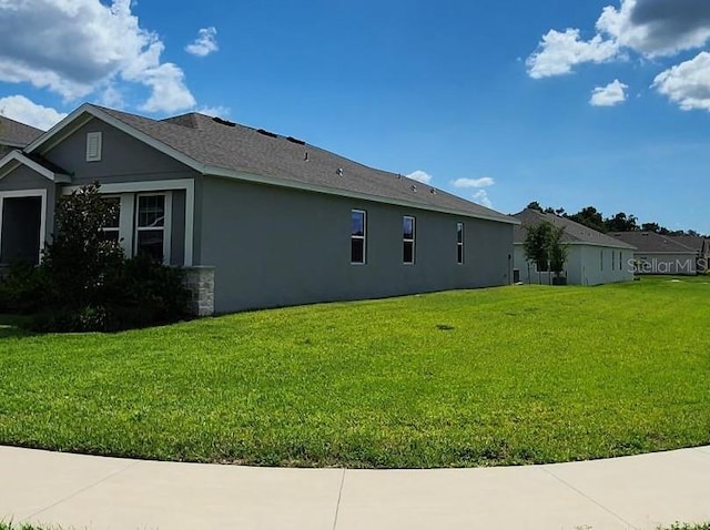 483 Shadow Gorge Way, Eustis, FL 32736 - view of property exterior featuring stucco siding and a lawn