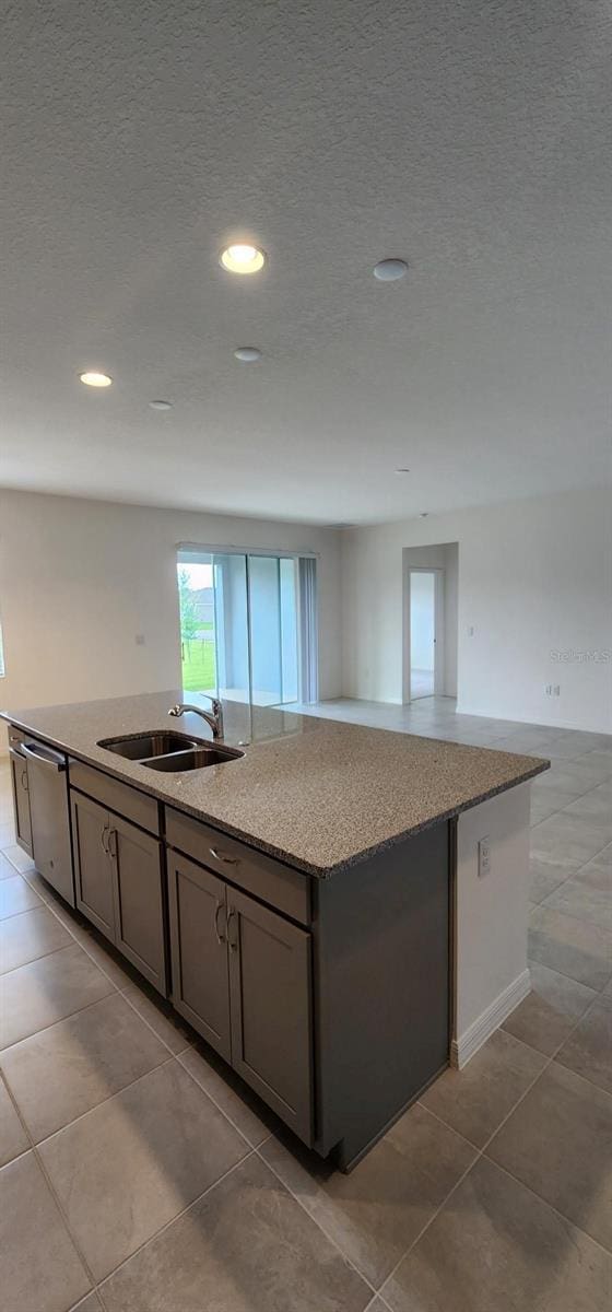 483 Shadow Gorge Way, Eustis, FL 32736 - kitchen featuring a center island with sink, stainless steel dishwasher, tile patterned flooring, recessed lighting, and open floor plan