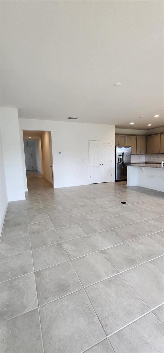483 Shadow Gorge Way, Eustis, FL 32736 - unfurnished living room featuring recessed lighting and light tile patterned floors