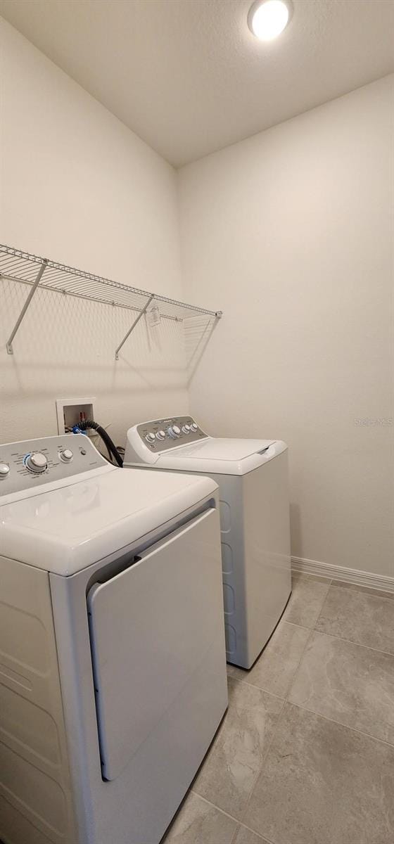 483 Shadow Gorge Way, Eustis, FL 32736 - laundry area featuring washer and clothes dryer and baseboards