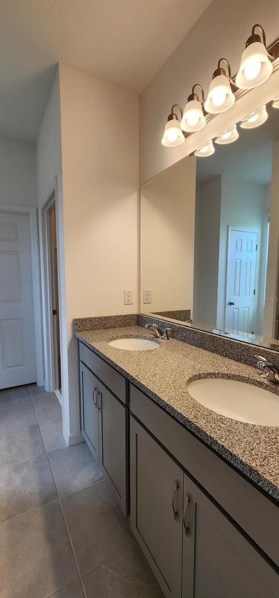 483 Shadow Gorge Way, Eustis, FL 32736 - full bath with double vanity, tile patterned floors, and a chandelier