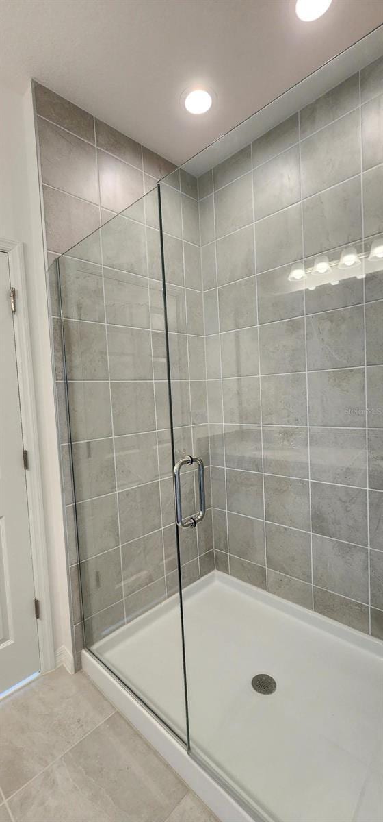 483 Shadow Gorge Way, Eustis, FL 32736 - bathroom featuring tile patterned flooring, a shower stall, and recessed lighting