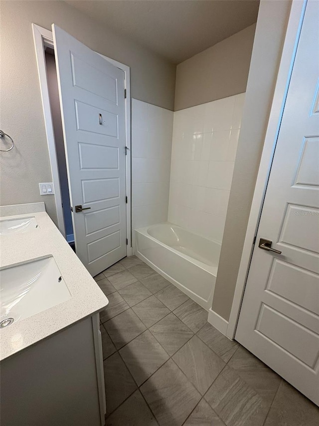 2318 Raven Ridge Rd, Minneola, FL 34715 - bathroom featuring double vanity, tile patterned floors, and a bathtub