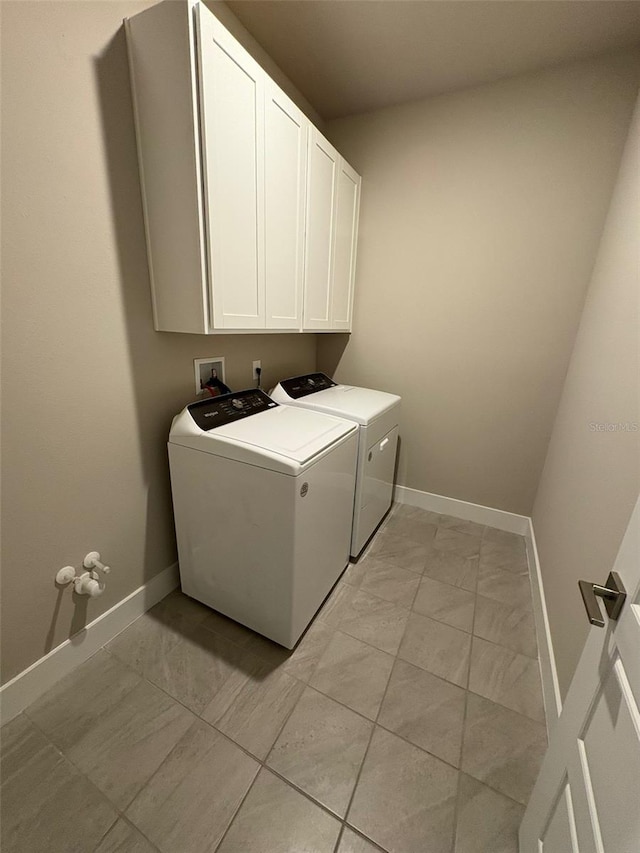 2318 Raven Ridge Rd, Minneola, FL 34715 - washroom featuring washer and dryer, cabinet space, and light marble finish flooring