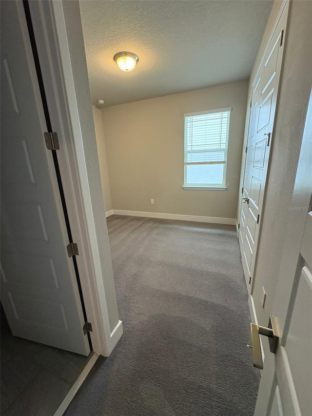 2318 Raven Ridge Rd, Minneola, FL 34715 - hall with dark carpet and a textured ceiling