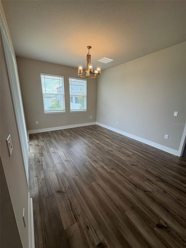 2318 Raven Ridge Rd, Minneola, FL 34715 - empty room featuring a chandelier and dark wood-style flooring