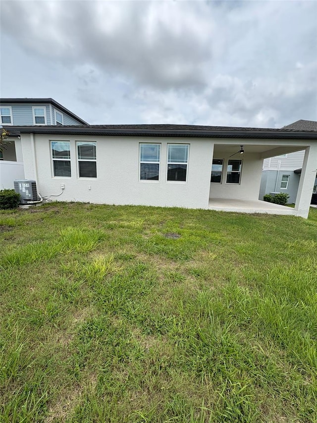 2318 Raven Ridge Rd, Minneola, FL 34715 - rear view of house featuring a patio area, stucco siding, and a yard