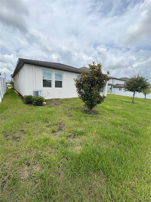2318 Raven Ridge Rd, Minneola, FL 34715 - view of side of property featuring stucco siding and a central AC unit
