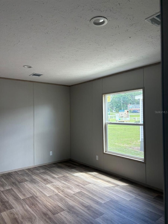 1349NW 109th Ave, Ocala, FL 34482 - unfurnished room featuring wood finished floors, a textured ceiling, and recessed lighting