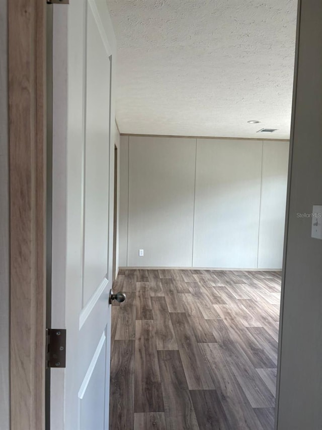 1349NW 109th Ave, Ocala, FL 34482 - spare room with a textured ceiling, wood finished floors, and a decorative wall