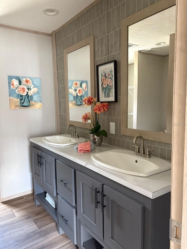 1349NW 109th Ave, Ocala, FL 34482 - bathroom featuring double vanity, wood finished floors, and backsplash