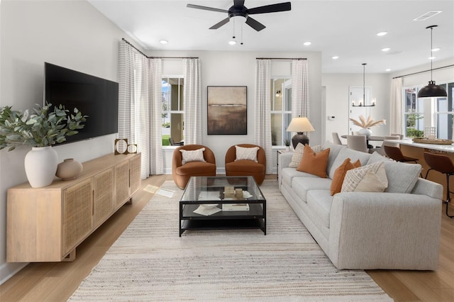 2486 Celebration Blvd, Celebration, FL 34747 - living area featuring wood finished floors, a ceiling fan, a chandelier, and recessed lighting