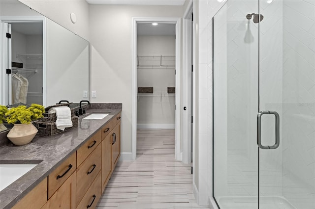 2486 Celebration Blvd, Celebration, FL 34747 - bathroom with double vanity, a walk in closet, and a shower stall