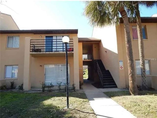5220 Via Hacienda Unit 212, Orlando, FL 32839 - view of building exterior with stairs