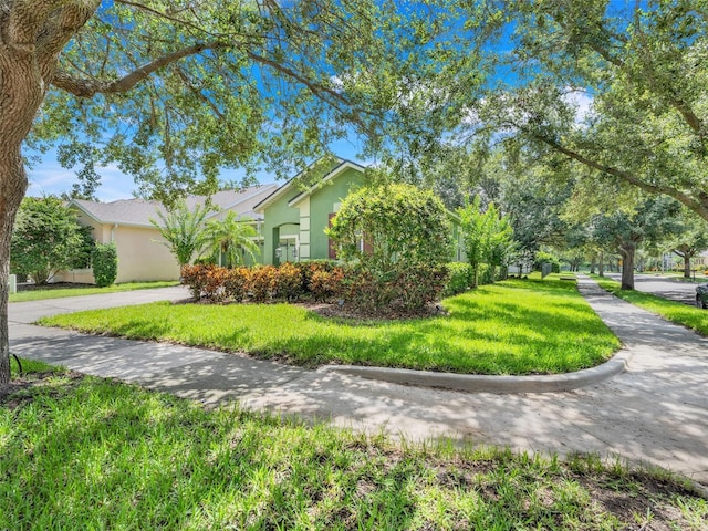 5263 Beach River Rd, Windermere, FL 34786 - view of front of home with stucco siding and a front yard