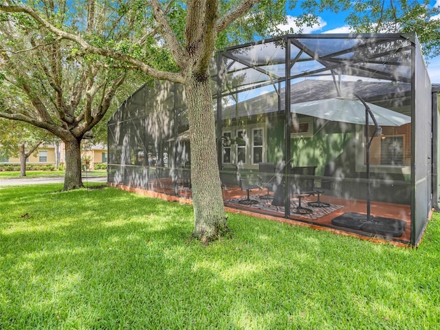 5263 Beach River Rd, Windermere, FL 34786 - back of house featuring a lawn and glass enclosure