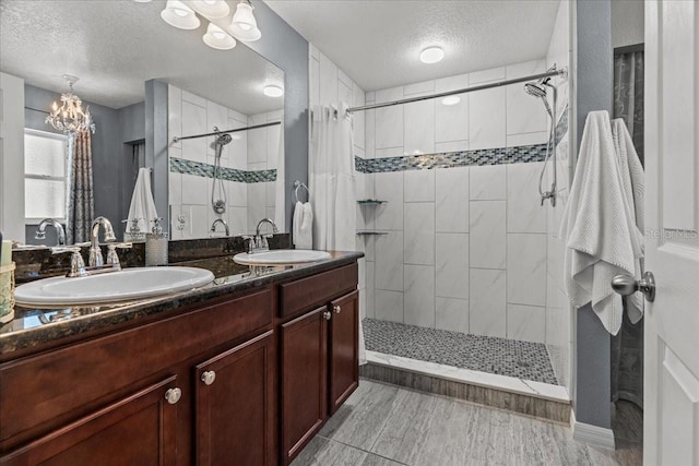 1787 Attilburgh Blvd, Melbourne, FL 32904 - full bathroom with a textured ceiling, a tile shower, double vanity, and a chandelier