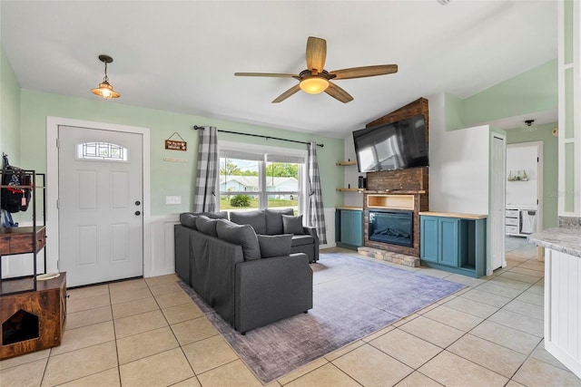 705 Ibis Ave, Deltona, FL 32738 - living area featuring light tile patterned floors, a glass covered fireplace, plenty of natural light, and vaulted ceiling