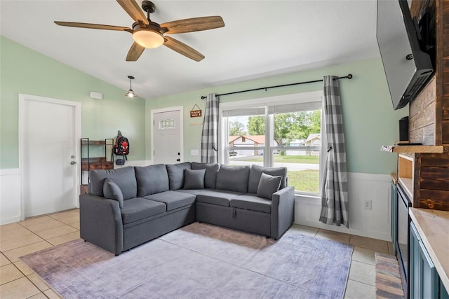 705 Ibis Ave, Deltona, FL 32738 - living room with light tile patterned floors, vaulted ceiling, wainscoting, and a ceiling fan