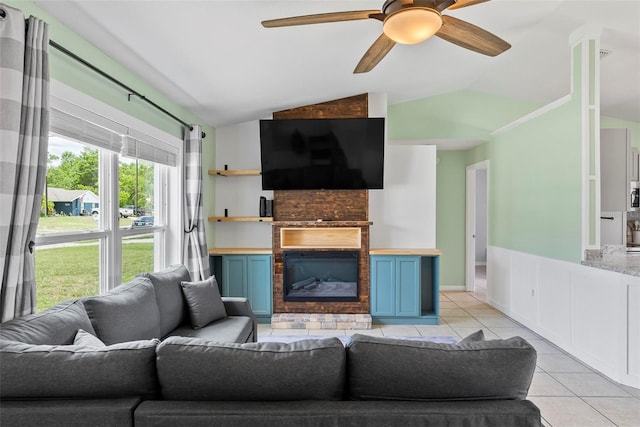 705 Ibis Ave, Deltona, FL 32738 - living area featuring lofted ceiling, light tile patterned floors, ceiling fan, and a large fireplace