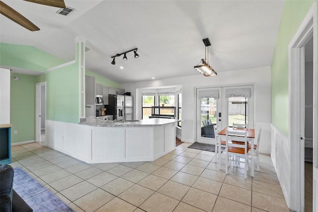 705 Ibis Ave, Deltona, FL 32738 - kitchen featuring appliances with stainless steel finishes, lofted ceiling, light tile patterned flooring, french doors, and a peninsula