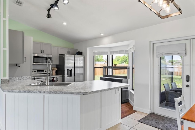 705 Ibis Ave, Deltona, FL 32738 - kitchen featuring appliances with stainless steel finishes, gray cabinets, light countertops, a peninsula, and lofted ceiling