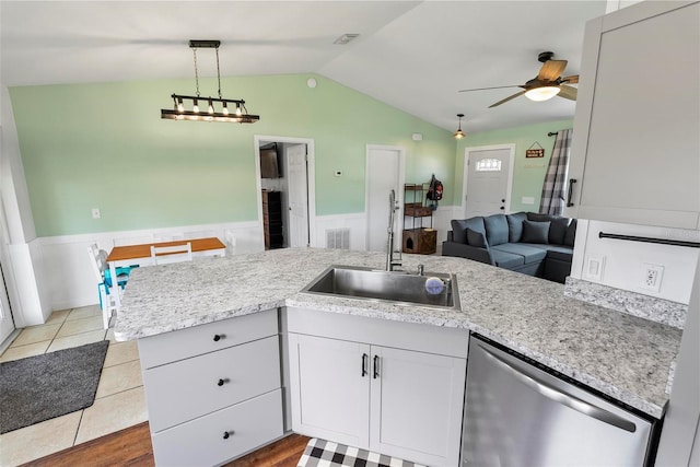 705 Ibis Ave, Deltona, FL 32738 - kitchen featuring dishwasher, a wainscoted wall, vaulted ceiling, ceiling fan, and open floor plan