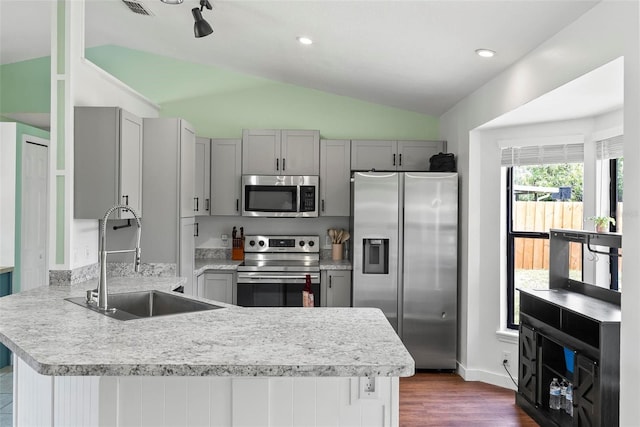 705 Ibis Ave, Deltona, FL 32738 - kitchen with stainless steel appliances, vaulted ceiling, gray cabinetry, a peninsula, and dark wood-type flooring