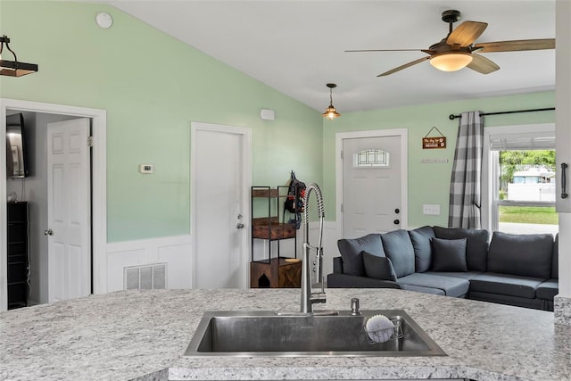 705 Ibis Ave, Deltona, FL 32738 - kitchen with lofted ceiling, ceiling fan, light countertops, and decorative light fixtures